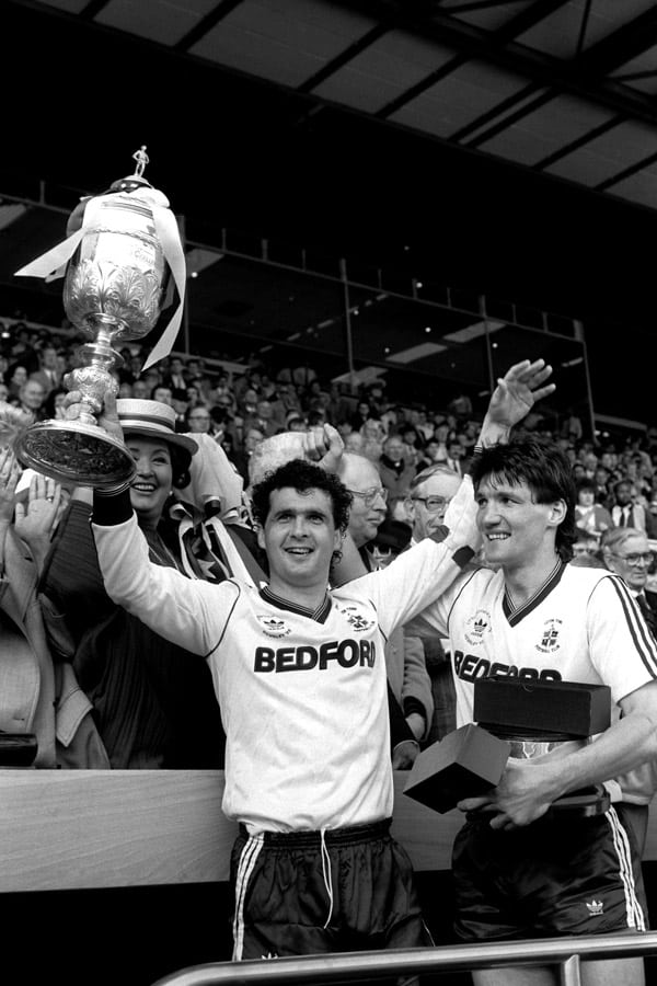 mick harford lifts the league cup trophy in 1988